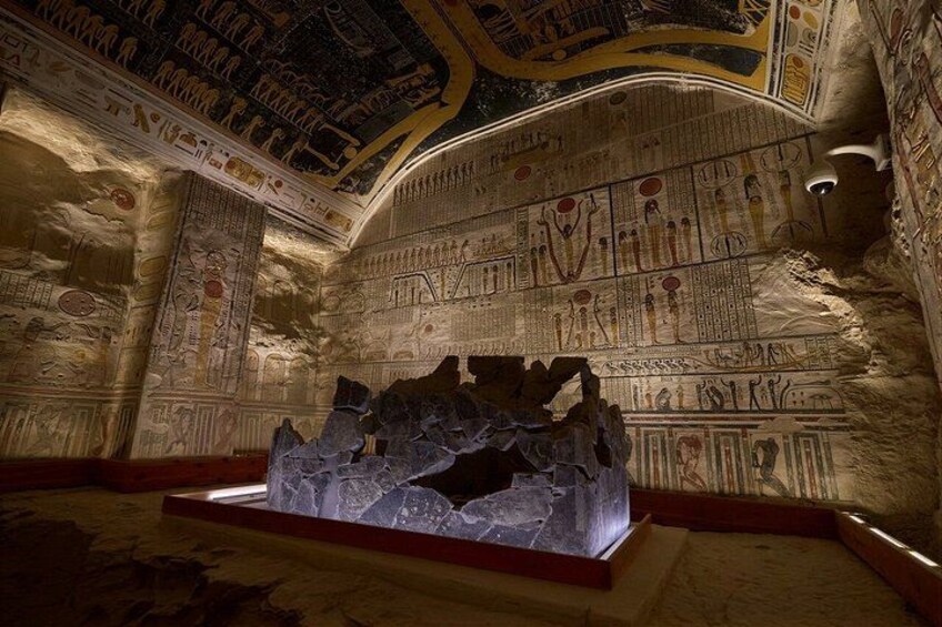 An ancient Egyptian tomb with hieroglyphs and a sarcophagus. 5