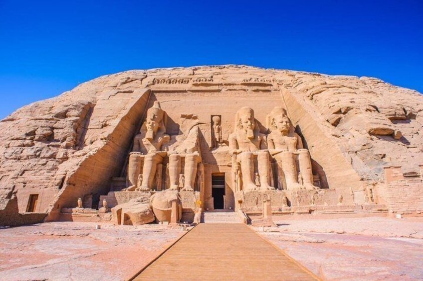 A large pyramid with a staircase leading to a temple entrance, featuring statues of pharaohs. 3