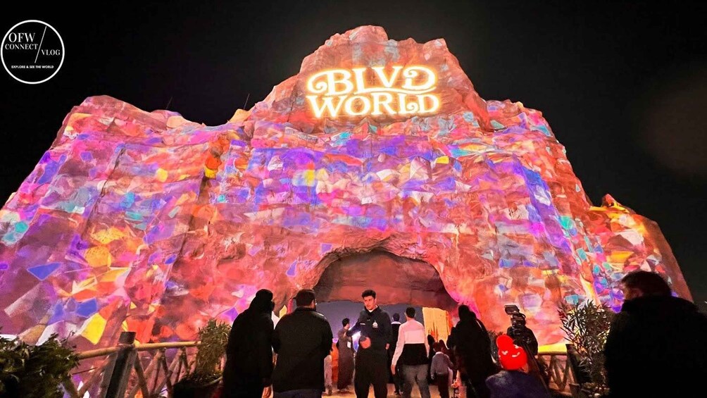 A brightly lit archway with the words 'BIVID WORLD' illuminated on it. 2