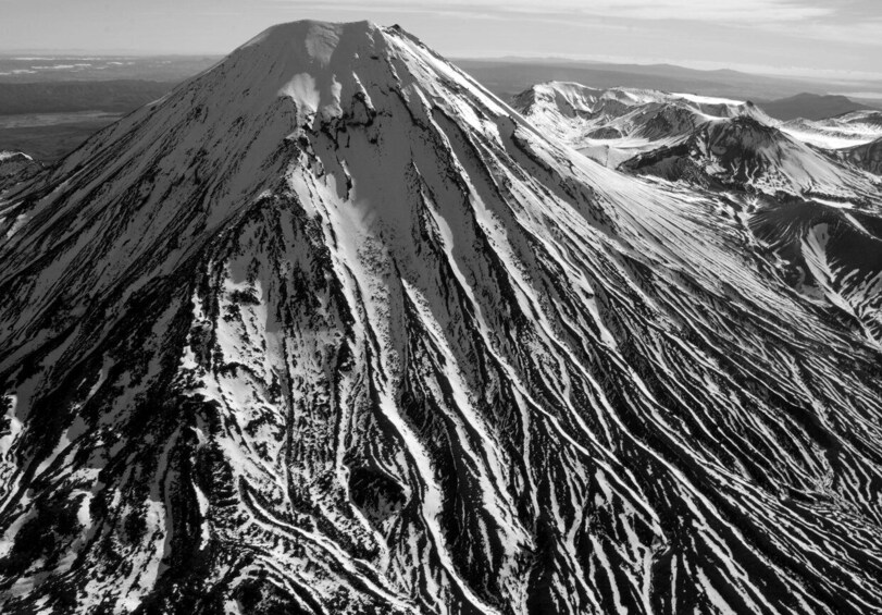 A snow-covered mountain with distinct ridges and valleys. 2