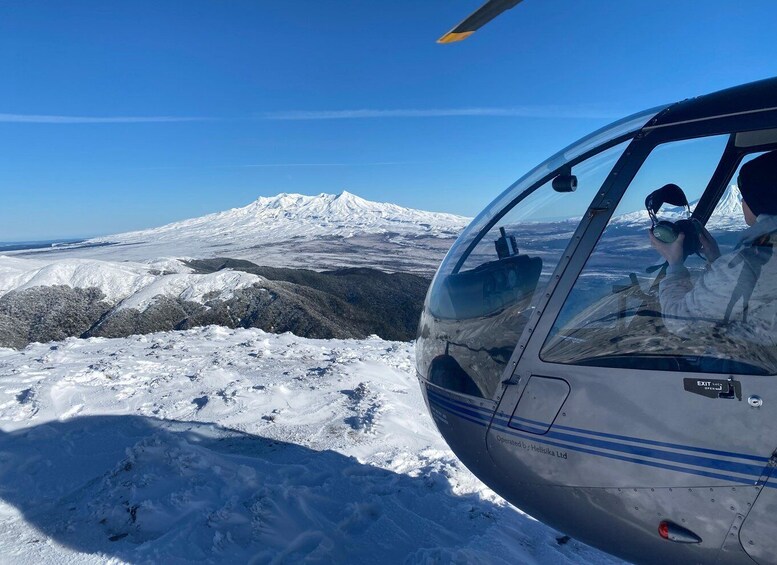 A helicopter with a snowy mountain landscape in the background. 5