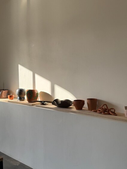 A collection of pottery on a shelf. 4
