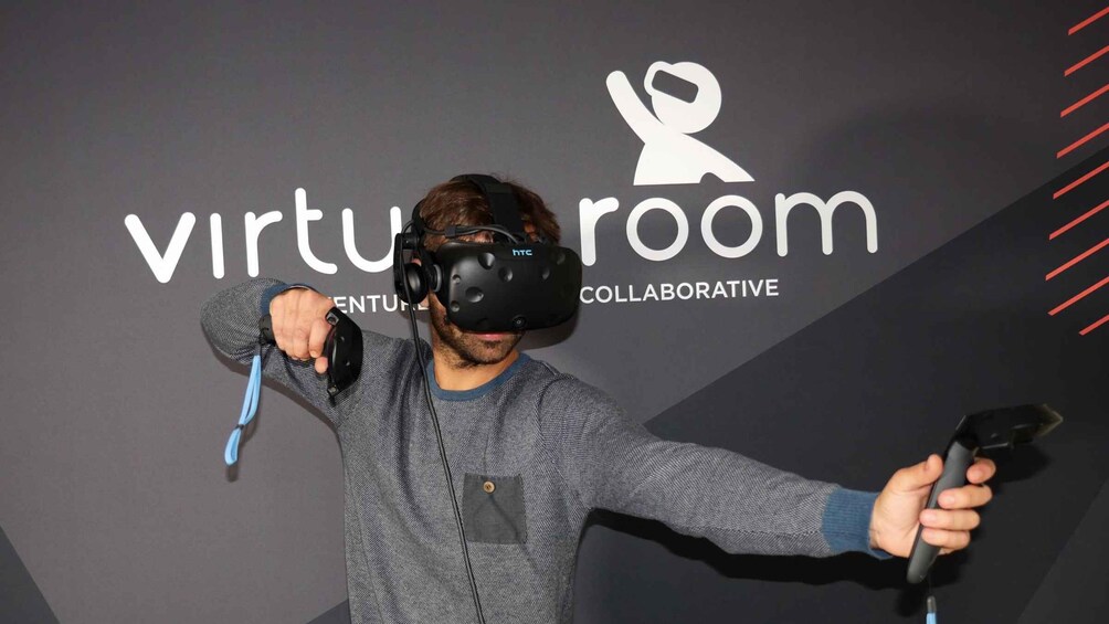 A person wearing a virtual reality headset holding a controller. 5