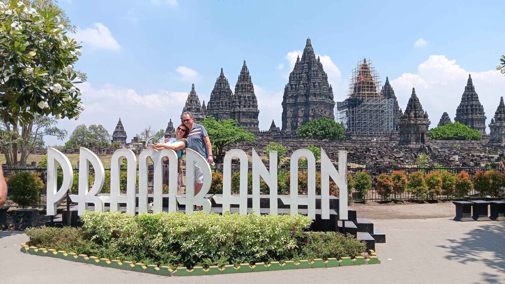 A large sign with the word 'PHOENIX' in front of a temple complex. 4