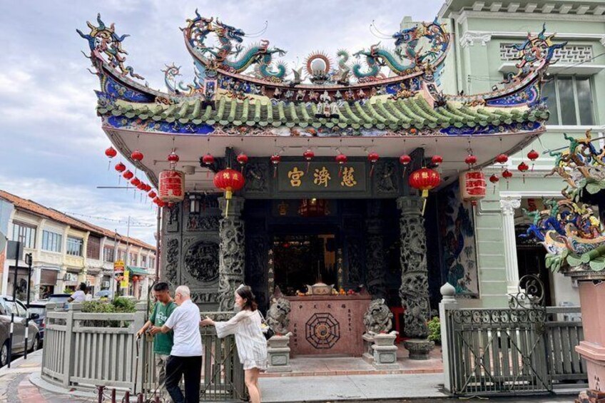 A traditional Chinese gate with intricate dragon carvings and red lanterns. 1