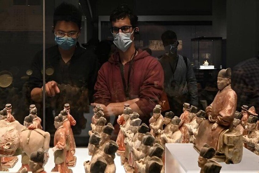 A display of ancient terracotta figures in a museum. 4