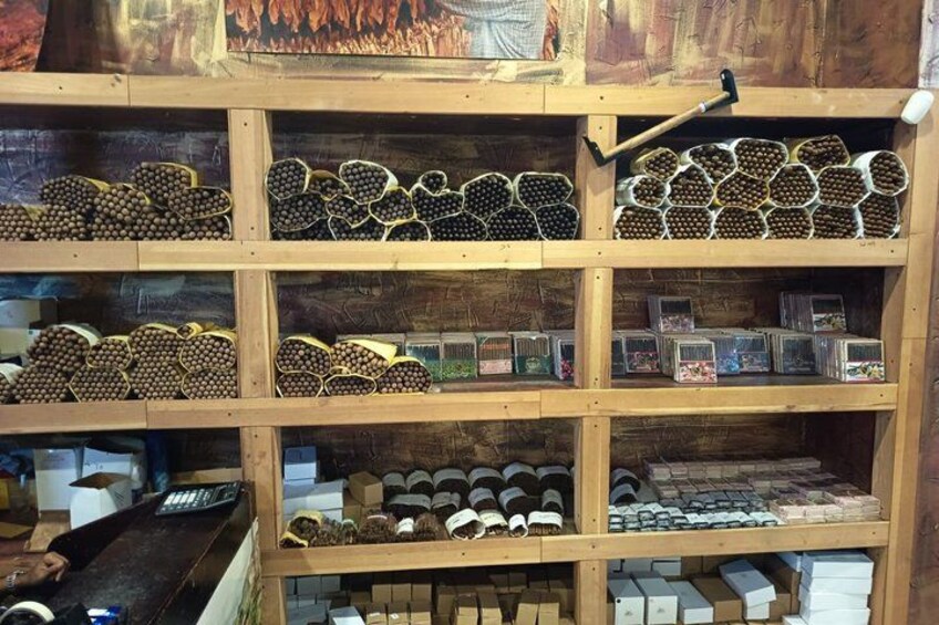 A wooden shelf with various items including heart-shaped objects, cylindrical containers, and small boxes. 2