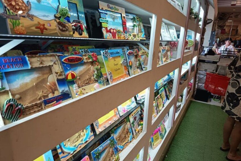 A display of beach-themed toys and books in a store. 5