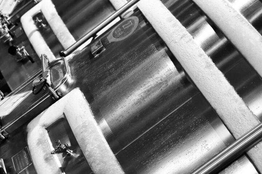 A close-up of a metallic surface with a textured pattern and a circular emblem. 1