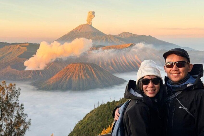 A volcanic landscape with a person and a companion standing on a hill. 5