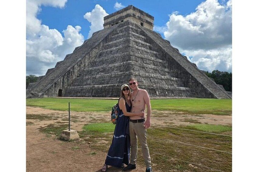 A large ancient pyramid with a clear sky and a few clouds. 2