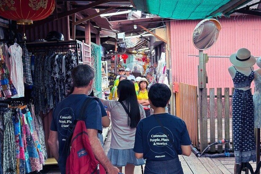 A market with people browsing stalls. 5