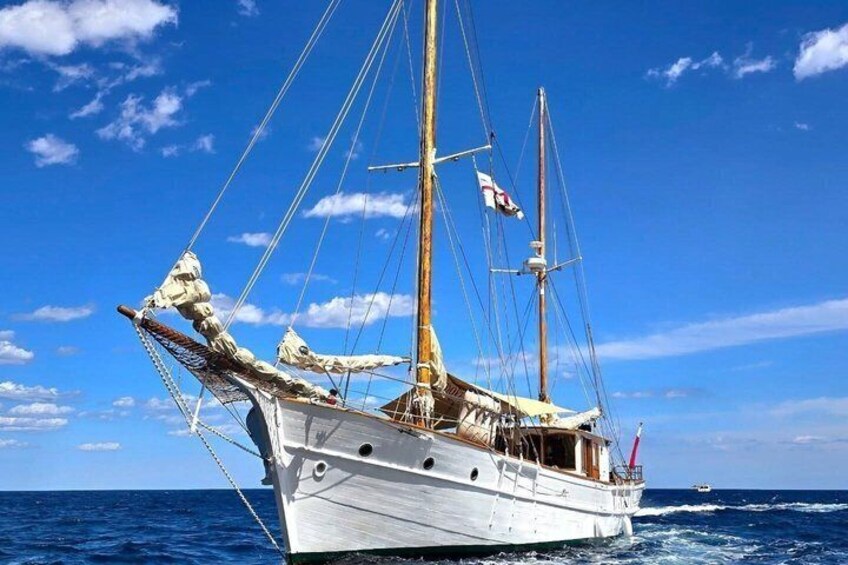 A sailing ship with multiple masts and sails, anchored in the ocean. 2