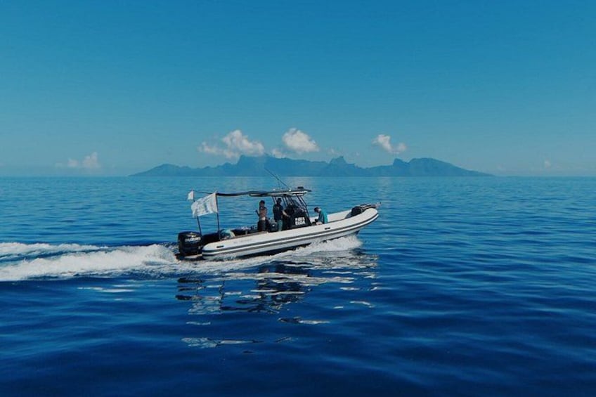 A boat on a calm sea with mountains in the background. 2