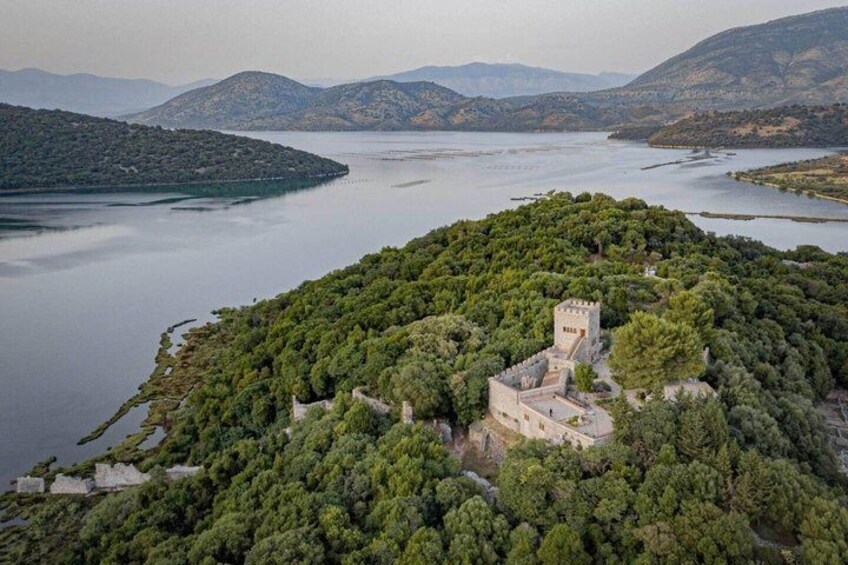 A castle surrounded by dense forest on a lake island. 1