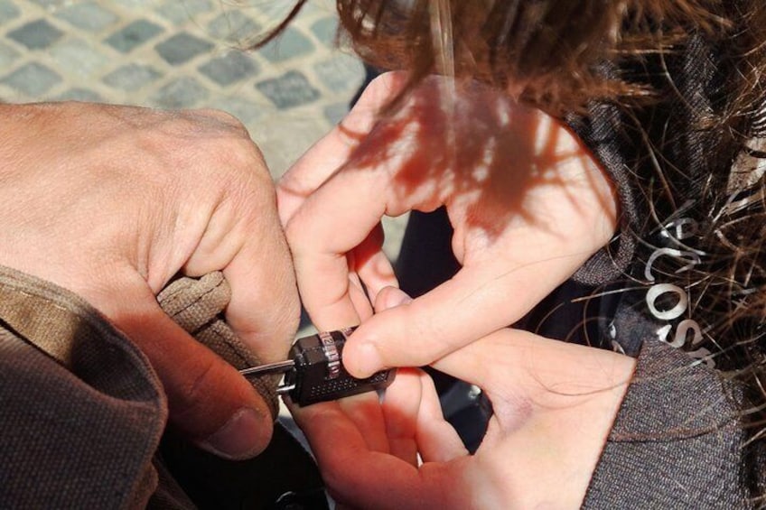 A person using a tool on another person's hand. 3