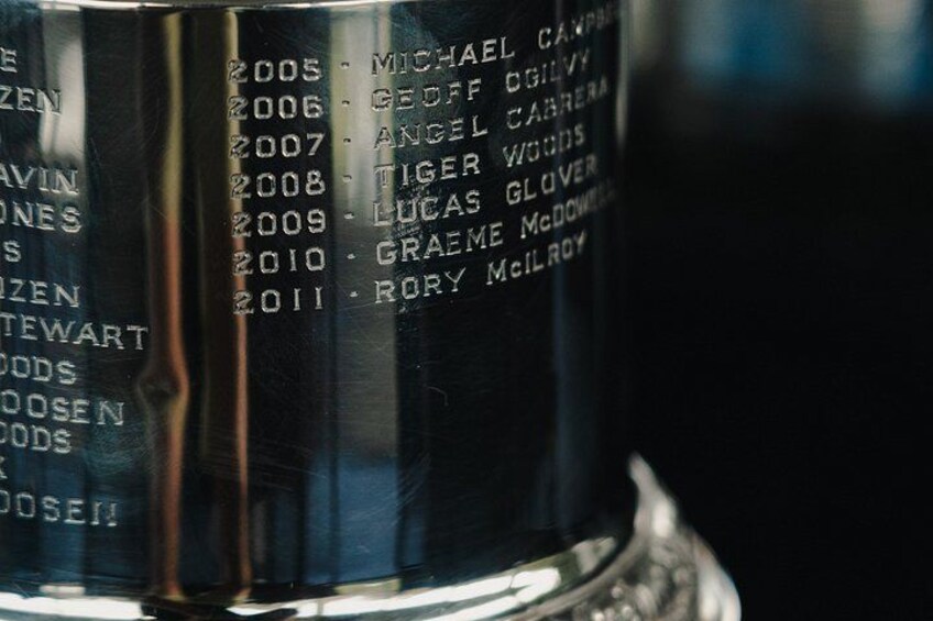 A metallic plaque with engraved names and years from 2005 to 2011. 4