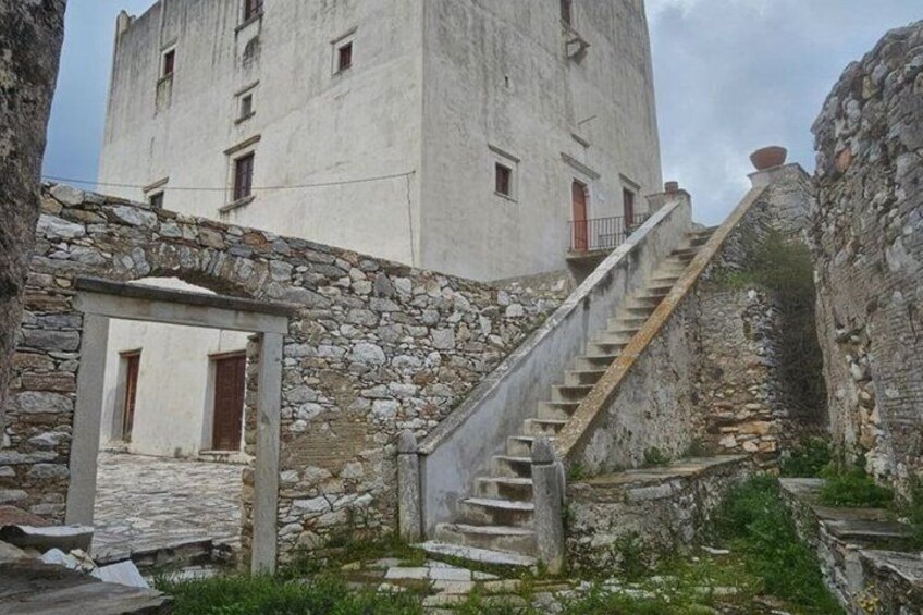 A stone staircase leading to a building with a white facade. 2