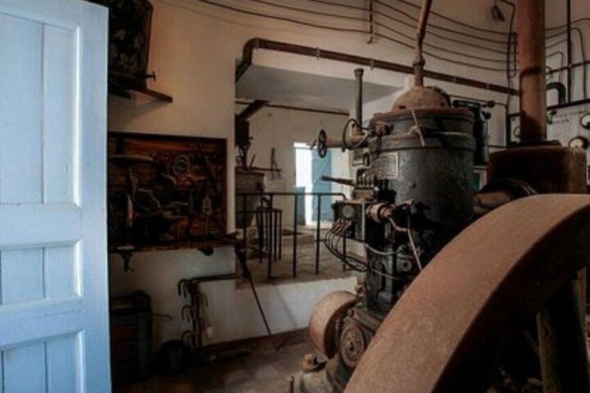 An industrial setting with machinery, pipes, and a door. 4