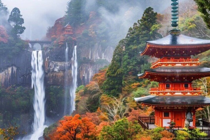 A traditional Japanese pagoda with a waterfall in the background. 1
