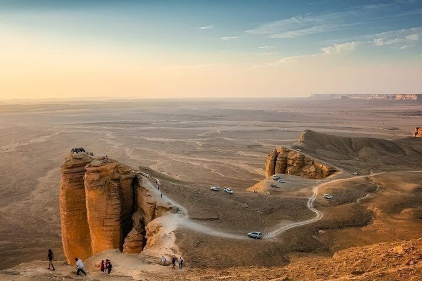 A desert landscape with rock formations and a winding road. 3