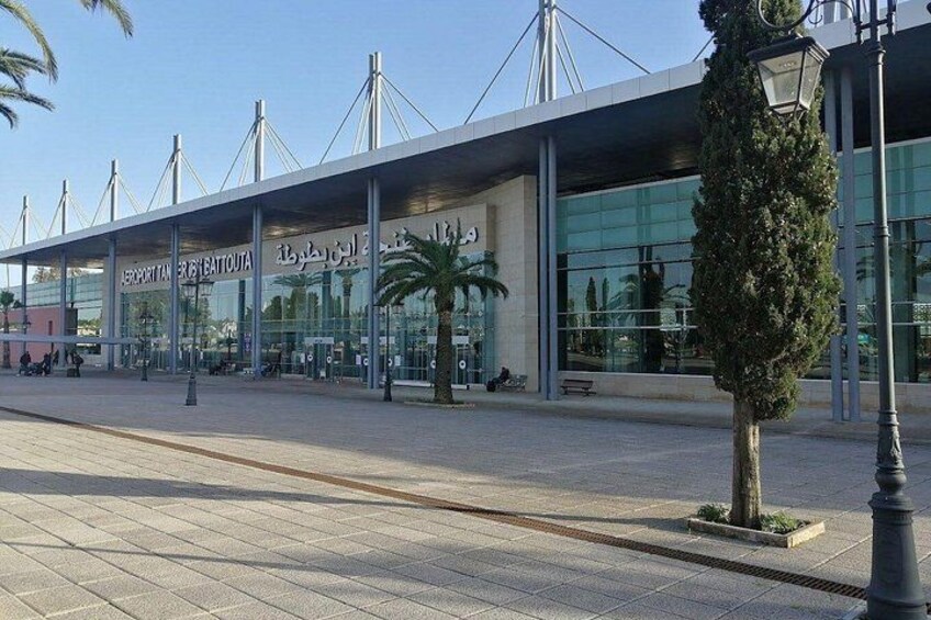 An airport terminal with a modern design, featuring a large glass facade and a distinctive roof structure. 2