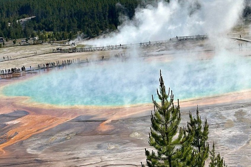A geothermal area with mineral deposits and steam rising from the ground. 3