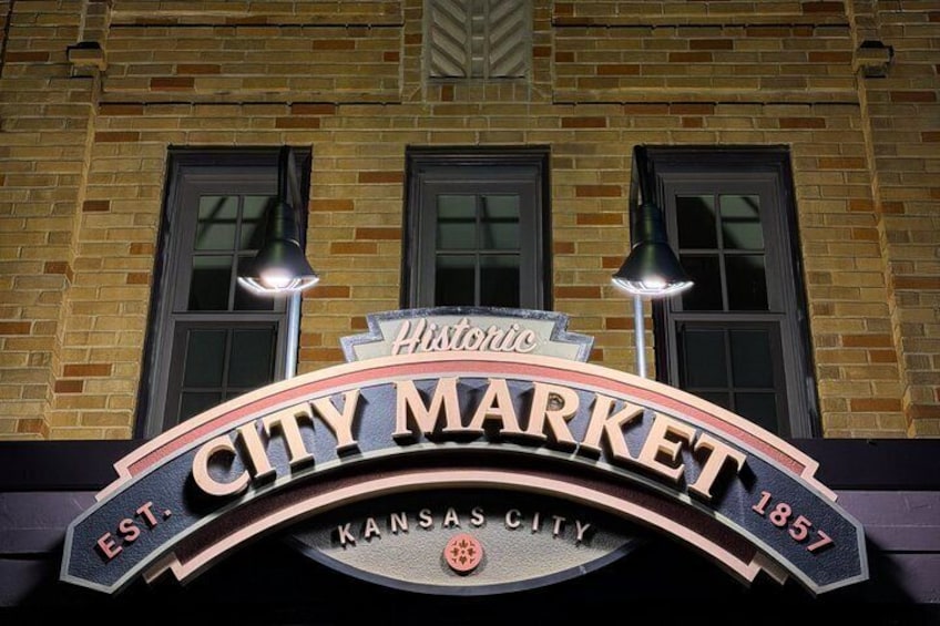 A historic building with a sign reading 'City Market' and 'Kansas City 1857'. 3