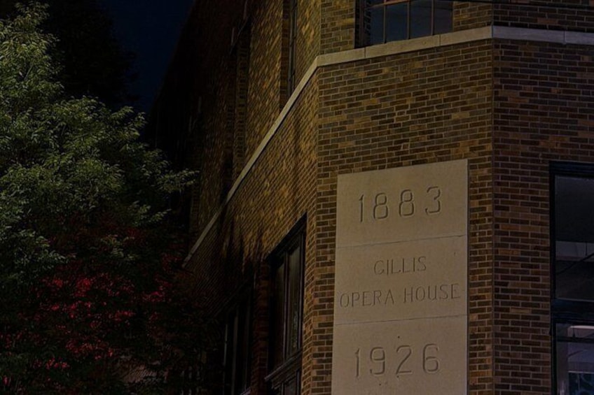 A brick building with a sign that reads '1883 GILLIS OPERA HOUSE 1926.' 2