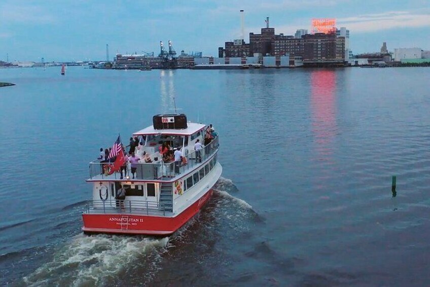 A ferry named 'Anna Olson II' moving across a body of water with a cityscape in the background. 5
