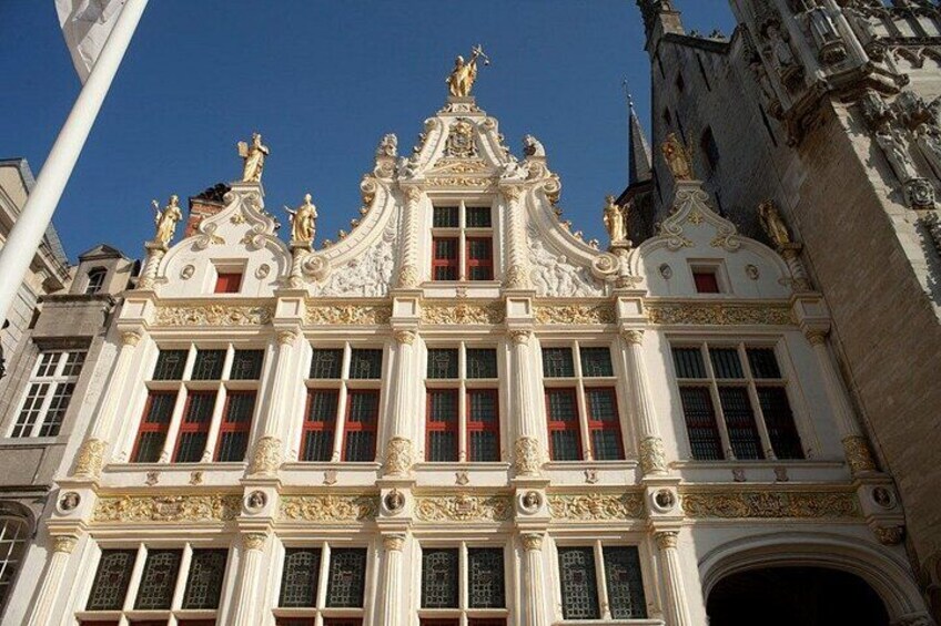A grand building with ornate architecture, including statues and decorative elements. 4