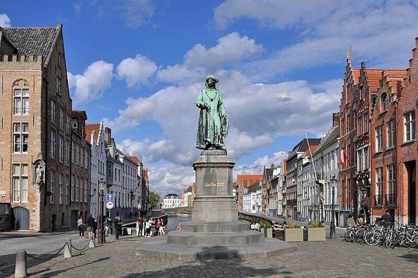 A statue in a square with buildings on either side. 5