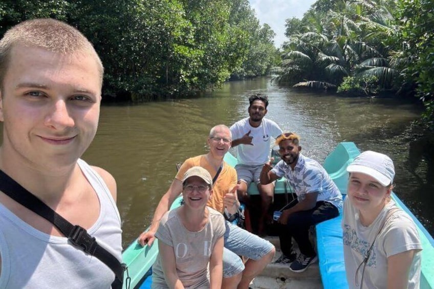 A group of people on a boat in a river surrounded by dense greenery. 1
