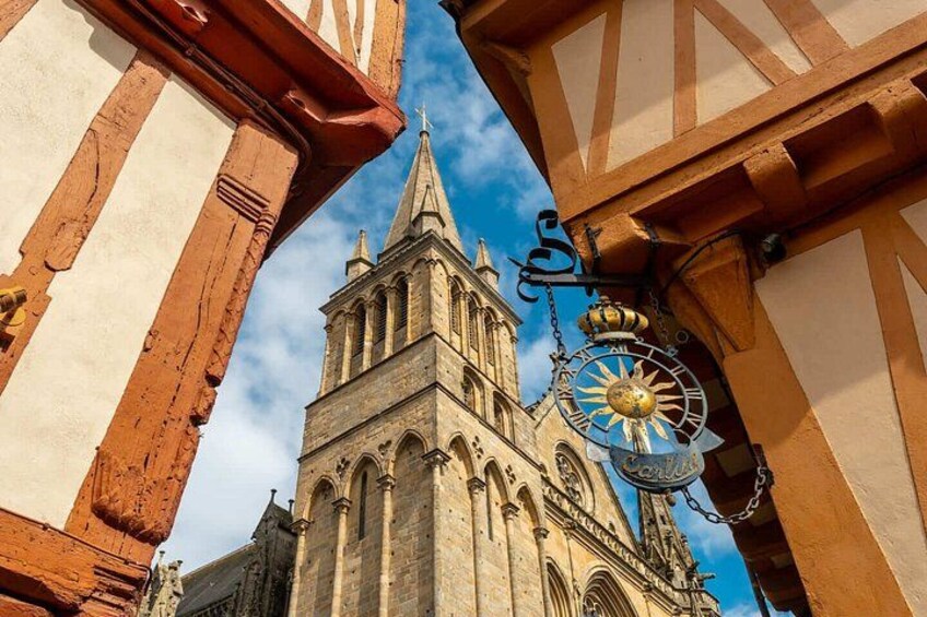 A historic church with a tall spire and a clock. 4