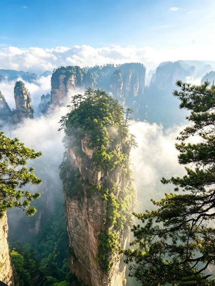 A mountainous landscape with towering rock formations and dense forest. 1