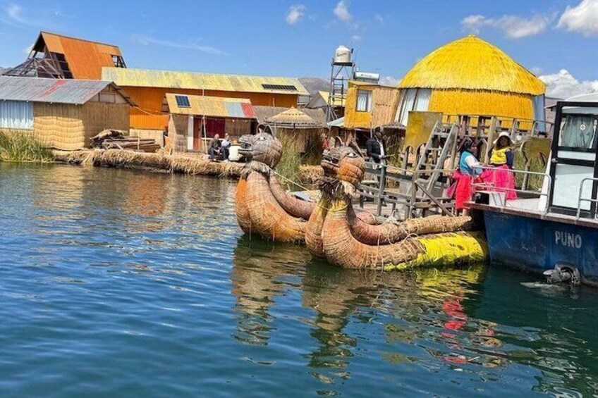 A traditional boat with a thatched roof, a person in a pink dress, and a building with a yellow roof. 4