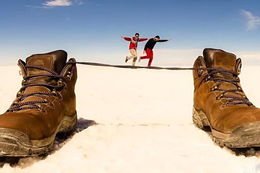 A person walking on a rope between two boots. 2