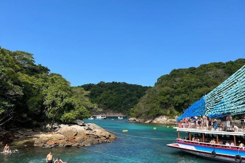 A river with boats, a dock, and lush greenery. 3