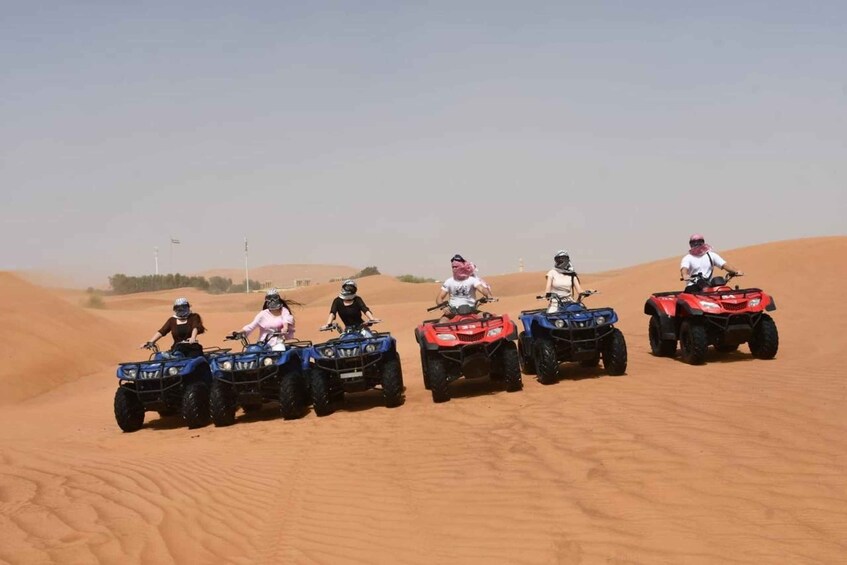 A group of people on ATVs in a desert landscape. 3