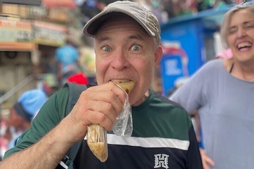A person eating a wrapped food item. 4