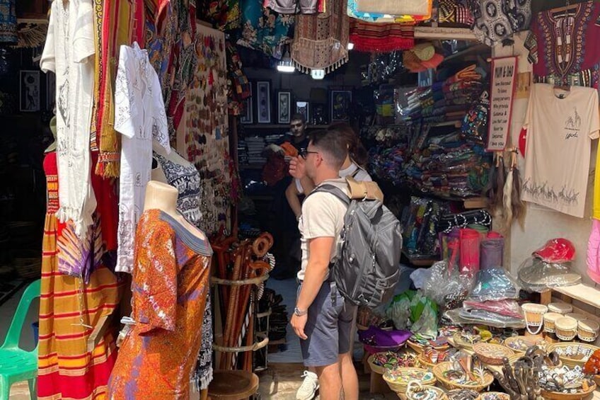 A market stall with various textiles and accessories. 2
