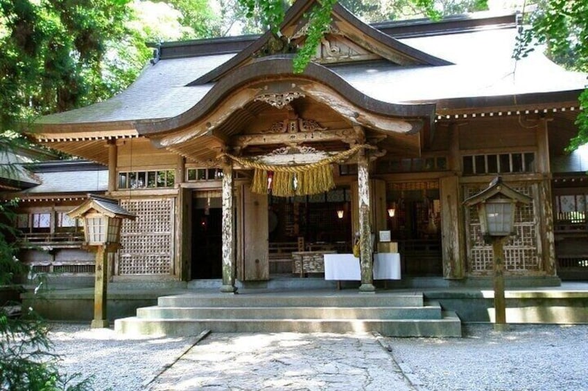 A traditional Japanese building with a wooden structure, a tiled roof, and a stone entrance. 5