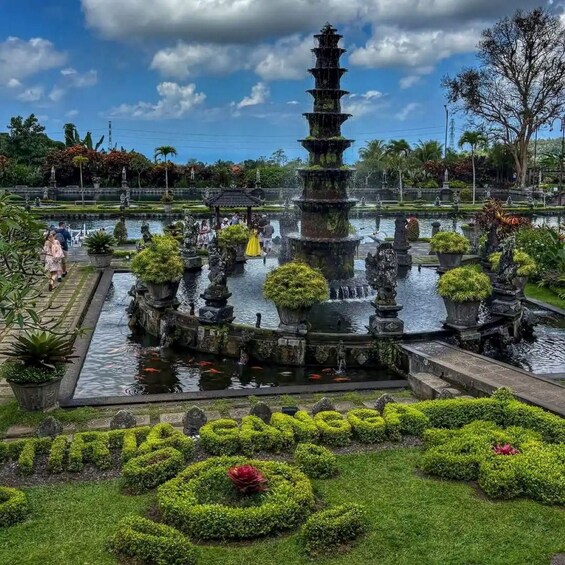 A traditional Japanese garden with a multi-tiered water fountain, koi fish, and well-manicured greenery. 5