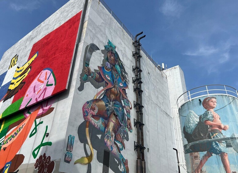 A mural with a figure holding a staff, a large red and white structure, and a circular window. 1
