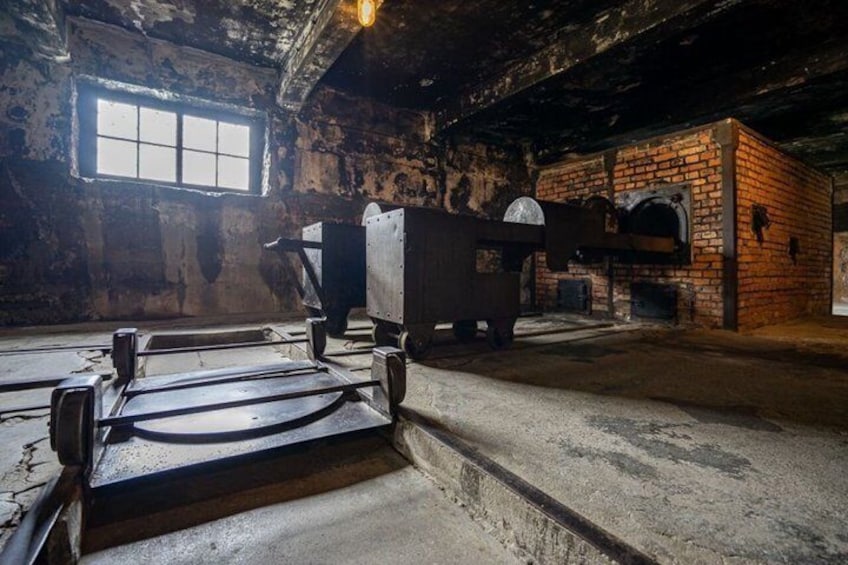 An old industrial building with a large metal structure, a brick oven, and a window. 2
