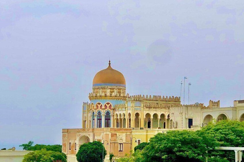 A large, ornate building with a prominent dome and arched windows. 4