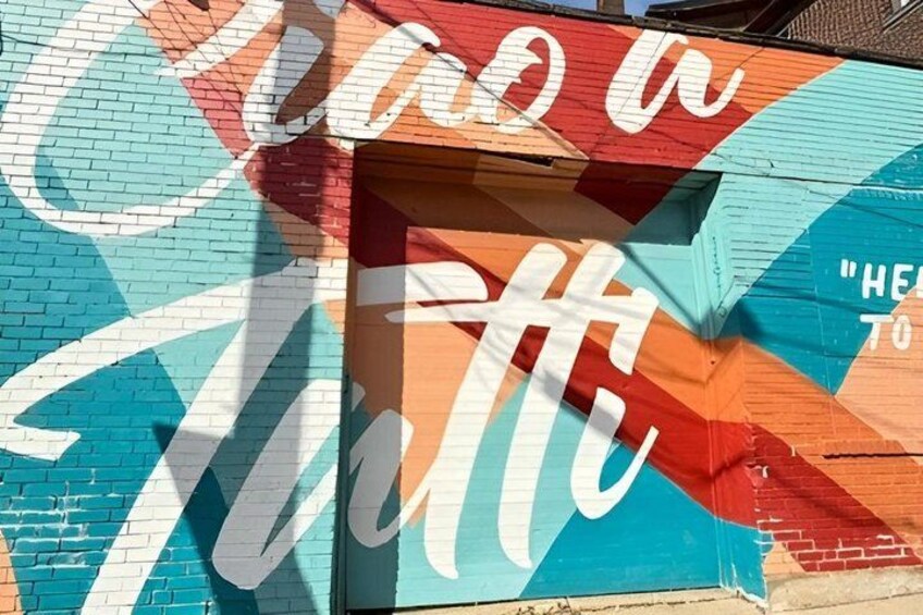 A colorful mural with large letters and geometric shapes. 3