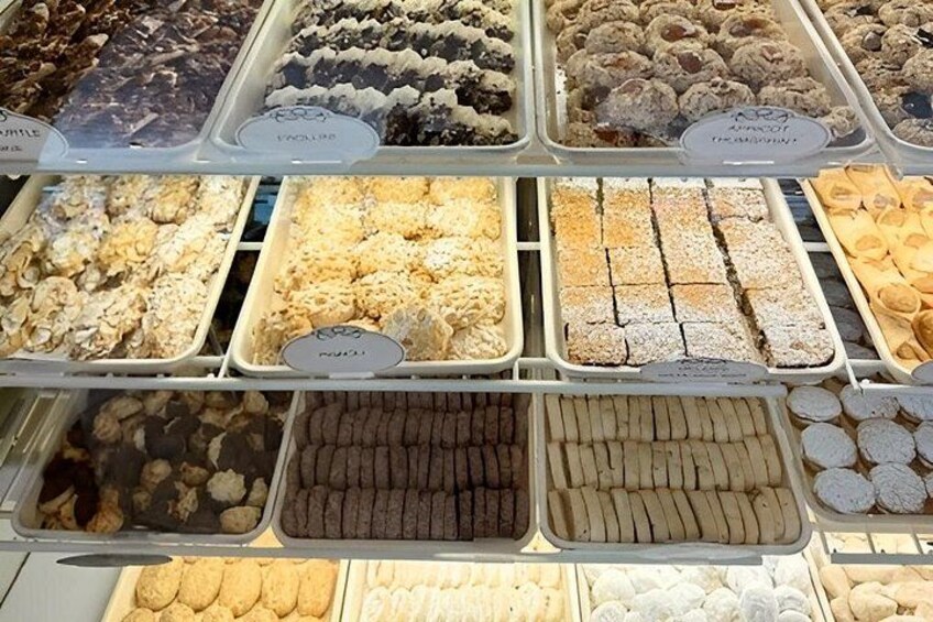 A bakery display with various types of pastries and desserts. 5