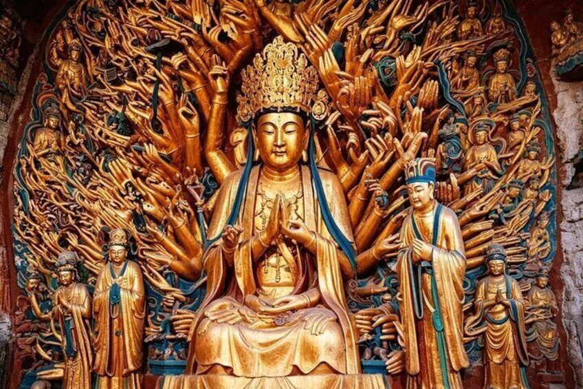 A large golden Buddha statue surrounded by smaller figures, set against a detailed background. 2