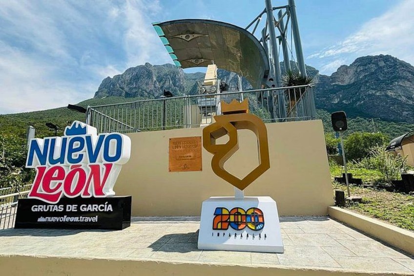 A sign for Nuevo Leon with a mountain backdrop. 5